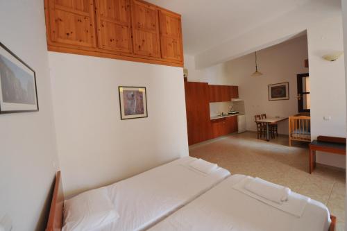 a bedroom with a bed and a living room at Odyssia in Symi