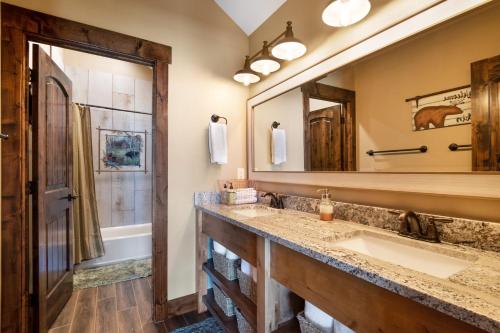 a bathroom with a sink and a mirror at Raspberry Ridge Lodge in Fish Haven