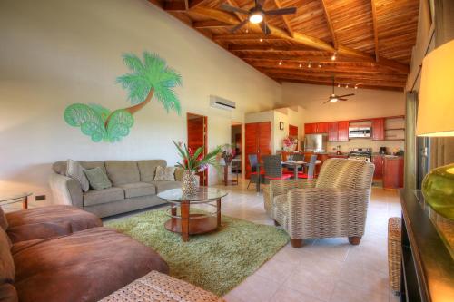 a living room with a couch and a table at Hidden Palms in Nosara