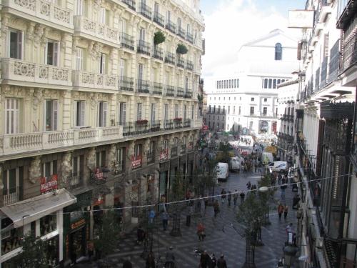 a city street with buildings and people walking on the street at Hostal Ivor in Madrid