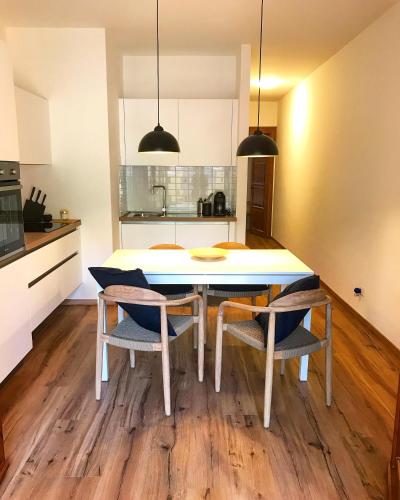 a kitchen and dining room with a table and chairs at The Suite in Santa Maria Navarrese