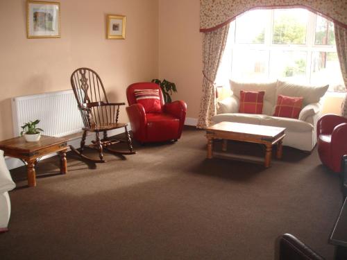 a living room filled with furniture and a window at Glencarse Hotel in Glencarse
