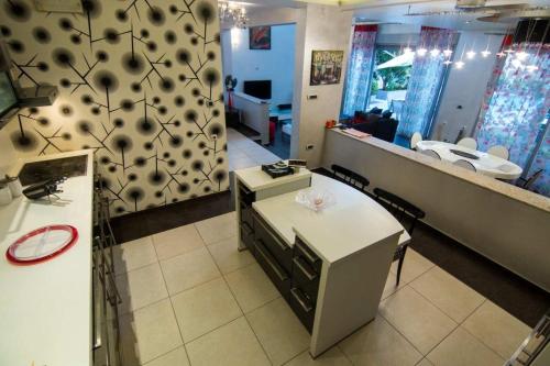 a room with a kitchen with a counter and a mirror at Lux Villa Ivan Budva in Budva