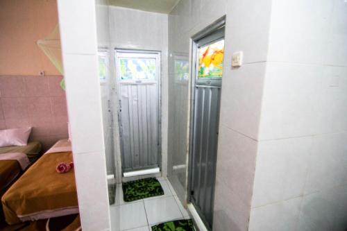 a shower in a room with a bed at Volcano Living in Kintamani