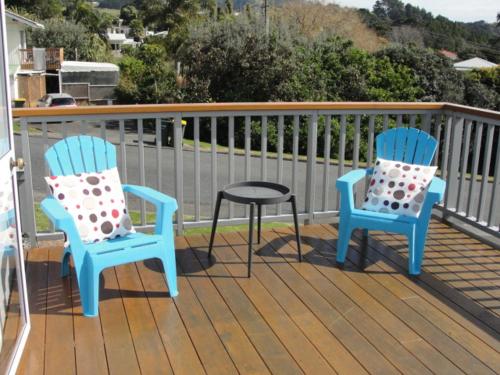 two blue chairs and a table on a deck at Leigh Panorama B&B in Leigh