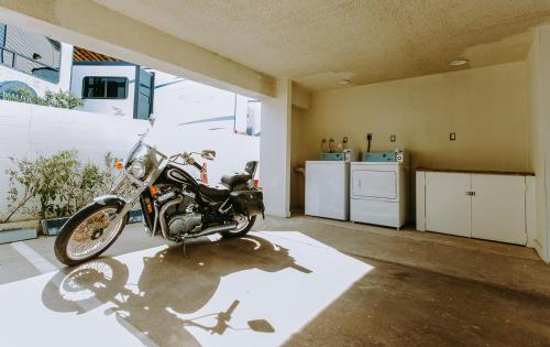a motorcycle parked in a room with a kitchen at Scottish Inn & Suites - Kemah Boardwalk in Kemah