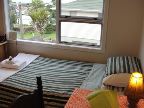 a small bedroom with a bed and a window at Leigh Panorama B&B in Leigh