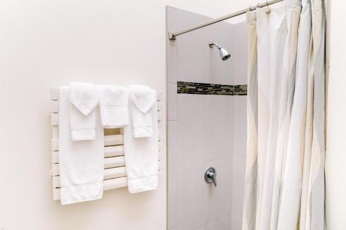 a bathroom with a shower with white towels at Kilauea Lodge and Restaurant in Volcano