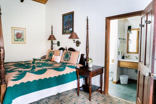 a bedroom with a bed and a sink at Kilauea Lodge and Restaurant in Volcano