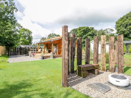 a wooden fence with a bench in a yard at The Chard in Carlisle