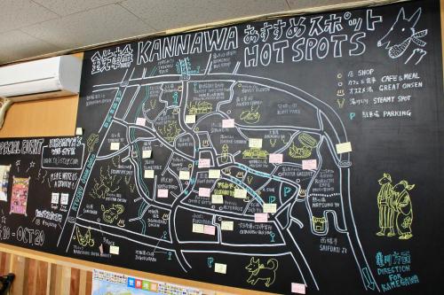 a chalkboard with a map ofhot spots on a wall at Beppu Kannawa Onsen HIROMIYA in Beppu