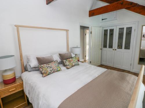 a bedroom with a large white bed with pillows on it at The Old Brewery in Saundersfoot