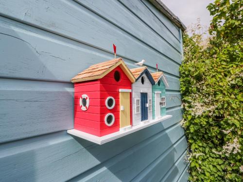 a toy house on the side of a building at Grebe Cottage in Oban