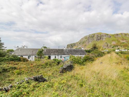 a house on the side of a hill at Grebe Cottage in Oban