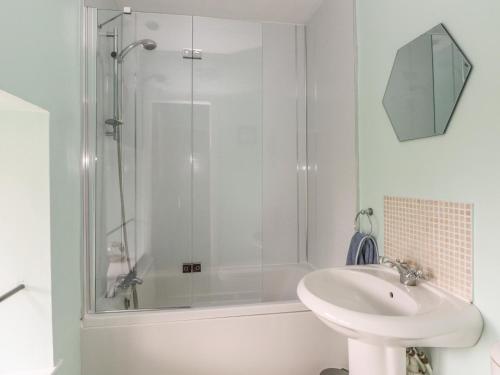 a bathroom with a shower and a sink at Cutlers Cottage in Matlock