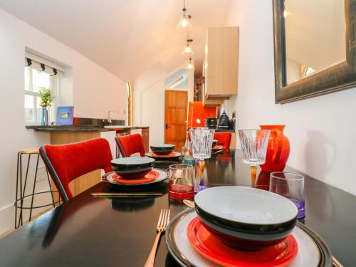 a dining room table with plates and glasses on it at The Hemmel in Faringdon
