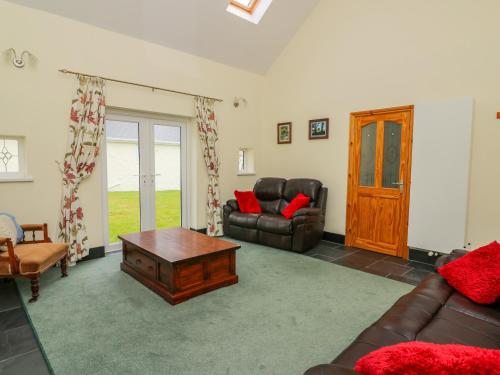 a living room with a couch and a coffee table at Hen Brynbedw in Llanybydder