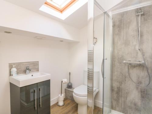 a bathroom with a shower and a toilet and a sink at The Croft in Chorley