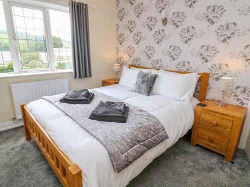 a bedroom with a bed with two towels on it at 2 Ings Avenue in Settle
