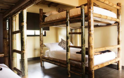 a bedroom with two bunk beds in a room at Paradise Project Hostal in Montañita