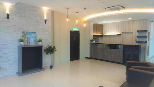 a lobby with a couch and a counter in a building at Legacy Hotel Ipoh in Ipoh