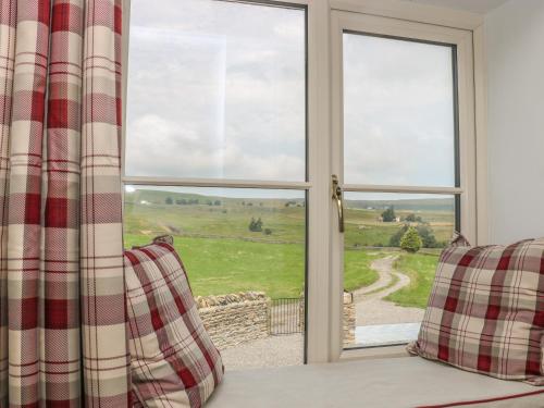 a room with a window looking out at a field at The Aspens in Barnard Castle
