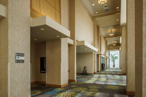 an empty hallway of a building with a hallwayngth at Hyatt Regency Orlando International Airport Hotel in Orlando
