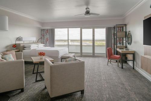 a hotel room with a bed and a desk and chairs at Hyatt Regency Orlando International Airport Hotel in Orlando