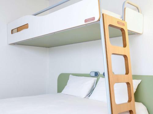 a bunk bed with a ladder in a room at ibis budget Caen Hérouville in Hérouville-Saint-Clair