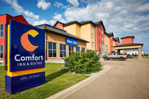 a c comfort inn and suites sign in front of a building at Comfort Inn & Suites in Red Deer