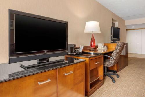 a hotel room with a large flat screen tv at Clarion Hotel Conference Center on Lake Erie in Dunkirk