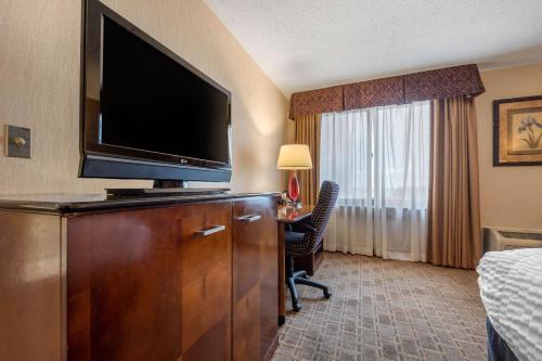 a hotel room with a flat screen tv on a dresser at Clarion Hotel Conference Center on Lake Erie in Dunkirk