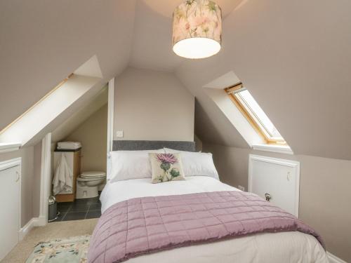 a bedroom with a bed in a attic at Little Lochlair in Forfar