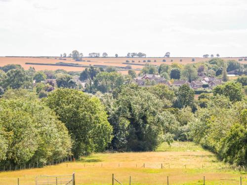 a field with trees and houses in the distance at Manor View in Oakham
