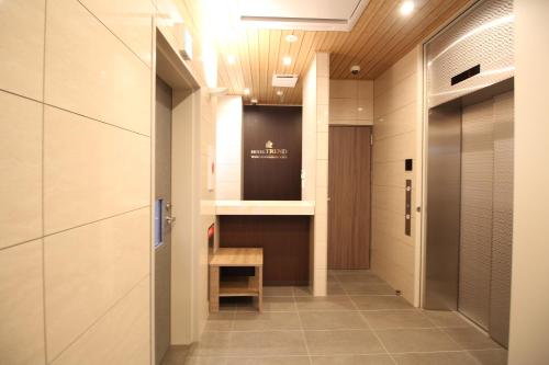 a hallway with a bench and a table in a building at Hotel Trend Tobu Asakusa-Eki Kita in Tokyo