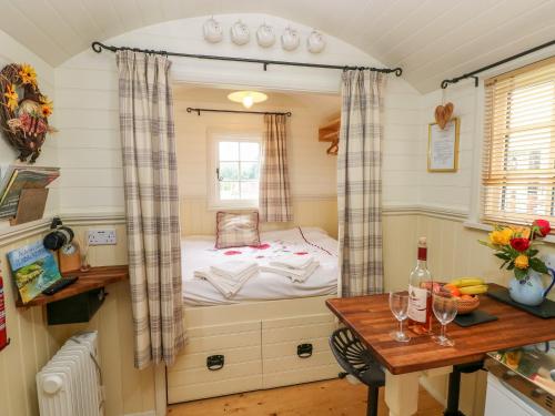 a small room with a small bed in a window at Shepherds Hut - The Crook in Milford Haven