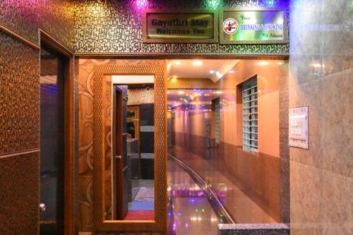 a hallway of a building with a mirror and lights at Gayathri Stay in Kanchipuram