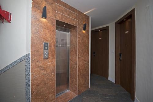 a bathroom with a walk in shower with a glass door at Hotel Vagmi in Varanasi