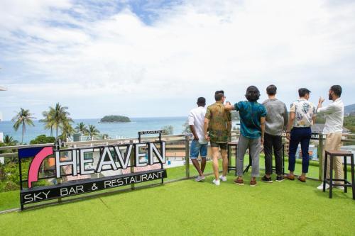 a group of people standing on a balcony looking at the ocean at Sugar Palm Grand Hillside - SHA Plus in Kata Beach