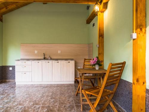 a kitchen with a table and chairs and a sink at Simada Green Guesthouse in Varshets