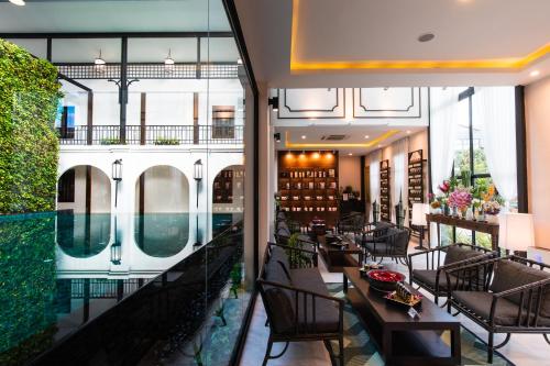 a view of the lobby of a hotel with tables and chairs at Phra Singh Village in Chiang Mai