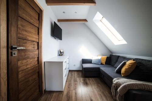 a living room with a couch and a door at Domek u Bronka in Białka Tatrzanska