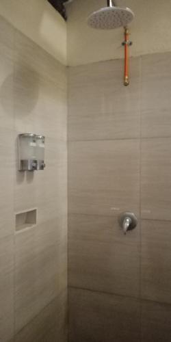 a bathroom with a shower with a shower head at ZiFa Mandalika in Kuta Lombok