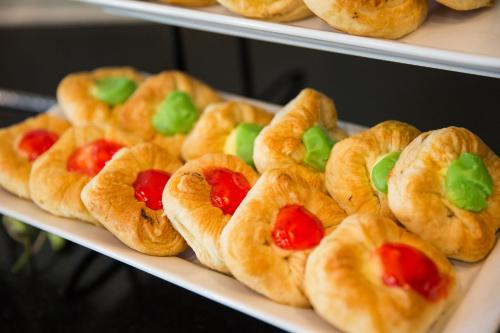 a plate of croissants with tomatoes and greens on them at Sugar Palm Grand Hillside - SHA Plus in Kata Beach