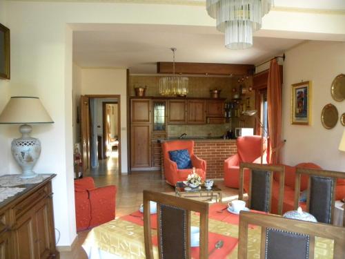 a living room with orange chairs and a couch at B&B Al Giardino in Monreale