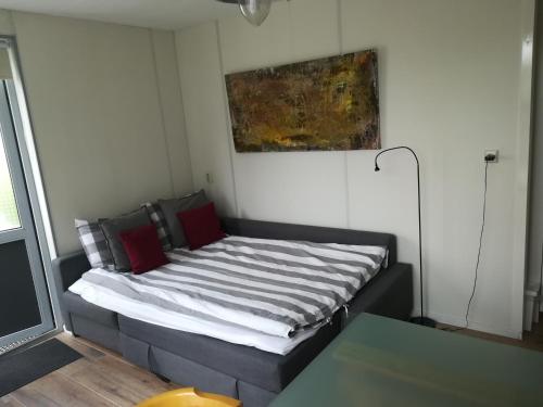 a couch in a room with a painting on the wall at Luxe Studio Bovenweg in Rhenen