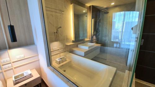 a bathroom with a sink and a shower with a mirror at The Astra,City center,Best view,Big room,5mins,Night Market in Chiang Mai