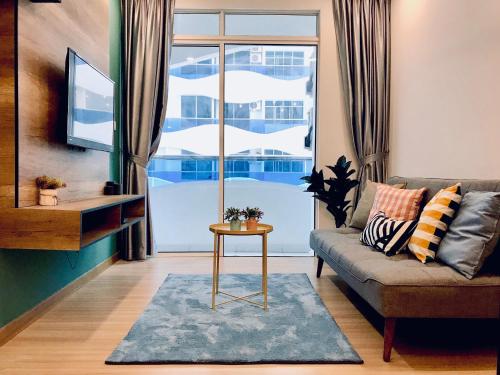 a living room with a couch and a window at The Wave Suites Melaka in Melaka