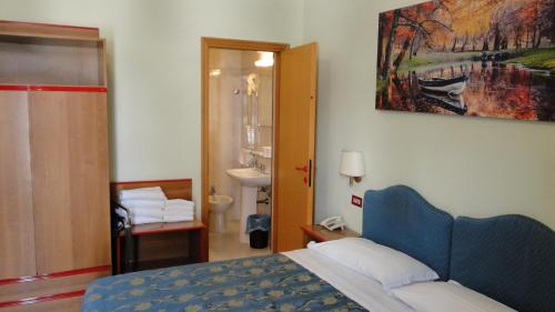 Postel nebo postele na pokoji v ubytování Hotel Altavilla Dieci