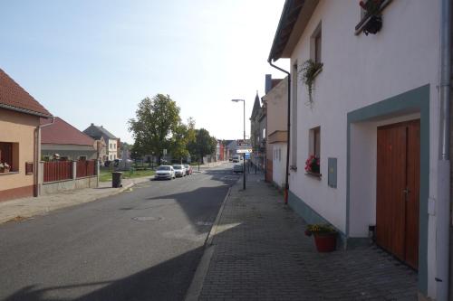 a street with cars parked on the side of a building at Apartmán Třebenice - vstupní brána do Českého středohoří in Třebenice